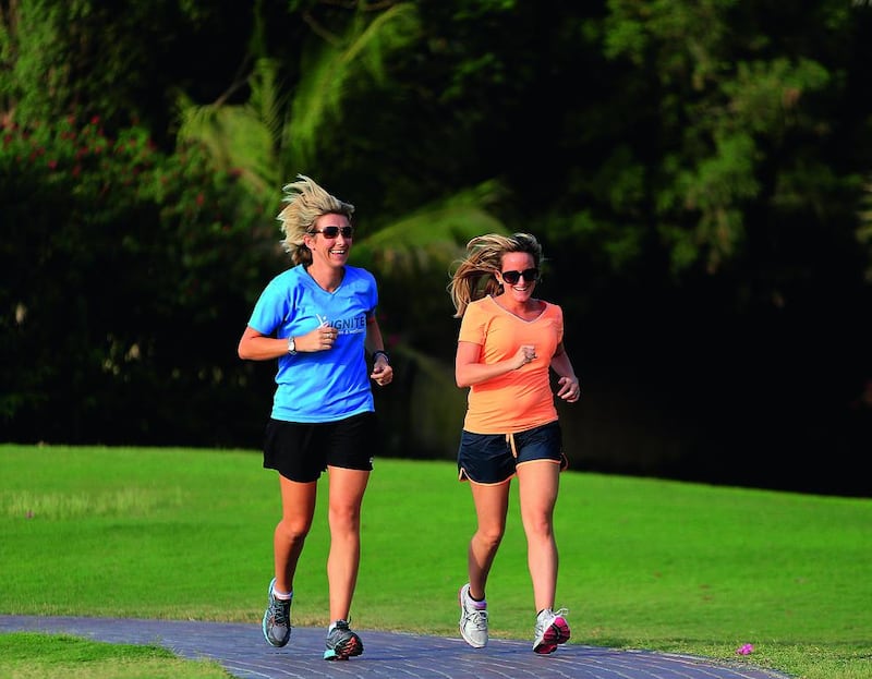 Alice Haine, right, with her personal trainer, Emma White, in Dubai. Altering her diet and fitness regime was part of a combination of approaches that helped Haine return to physical fitness in 11 months. Satish Kumar / The National