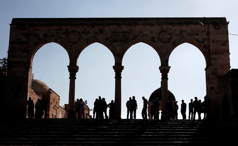 Palestinians are blocked on one side of the Al Aqsa mosque compound,  during the visit of a controversial Israeli MP after a ban on Israeli lawmakers visiting the holy site was lifted for one day. Ahmed Gharabli / AFP Photo