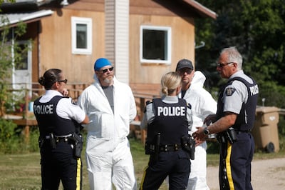 Forensics officials and police officers gather outside a crime scene where stabbing victim Wes Petterson was found, in Weldon, Saskatchewan, on Wednesday.  AFP