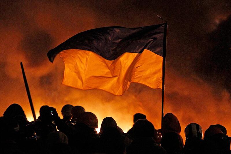 A demonstrator stands next to Interior Ministry members during a rally held by pro-European protesters in Kiev January 22, 2014. Ukrainian President Viktor Yanukovich has agreed to meet the three main opposition leaders on Wednesday for talks on a crisis that has led to violent clashes between protesters and police, said one of the leaders, Arseny Yatsenyuk.  REUTERS/Vasily Fedosenko (UKRAINE - Tags: POLITICS CIVIL UNREST)