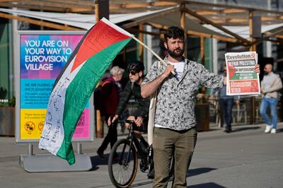 A man holds a Palestinian flag as he protests ahead of the first semifinal at the Eurovision Song Contest in Malmo, Sweden. AP 