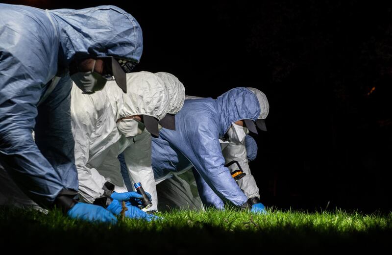 Police officers conduct a fingertip search of Poynders Road outside Poynders Court on the junction with Rodenhurst Road in London. Getty Images