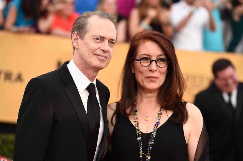 FILE - In this Jan. 25, 2015, file photo, Steve Buscemi, left, and his wife Jo Andres arrive at the 21st annual Screen Actors Guild Awards at the Shrine Auditorium in Los Angeles. Andres, a filmmaker and choreographer, has died. She was 64. Andres was married to Buscemi for more than three decades. Buscemi's representative, Staci Wolfe, confirmed Andres' death to The Associated Press on Sunday, Jan. 13, 2019. (Photo by Jordan Strauss/Invision/AP, File)