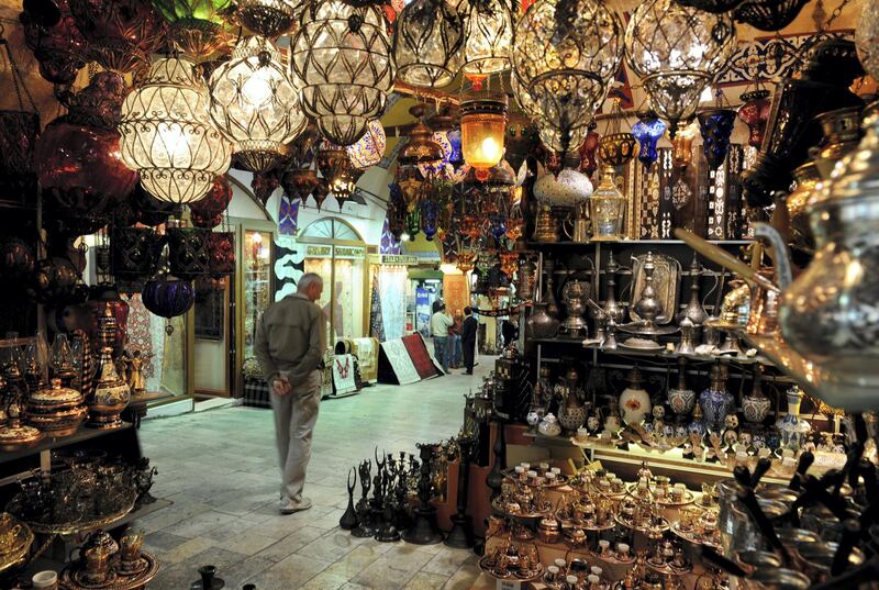 ISTANBUL, TURKEY - APRIL 02:  A man strolls past market stalls inside the Grand Bazaar on April 2, 2009 in Istanbul, Turkey. The Grand Bazaar is with it's around 58 streets and over 1200 shops one of the largest covered markets in the world attracting around 300,000 people daily.  (Photo by Jasper Juinen/Getty Images)