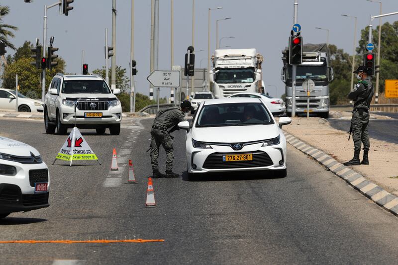 Israeli security force members stop a car as part of efforts to capture six Palestinian men who escaped from Gilboa prison in northern Israel. Reuters