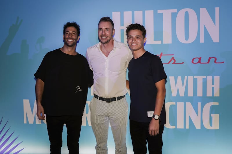 McLaren drivers Daniel Ricciardo and Lando Norris with actor Dax Shepard, centre, at a Miami Grand Prix event hosted by Hilton and McLaren Racing. AP