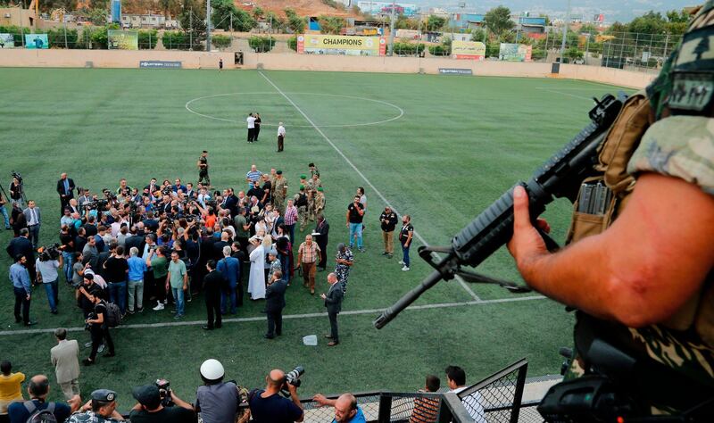 A member of the Lebanese security forces stands guard at Al-Ahed stadium in Beirut's southern suburbs as Lebanon's foreign minister gathered ambassadors near Beirut international airport during a tour of alleged missile sites. AFP