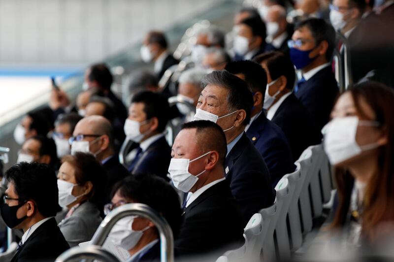 Officials wearing protective face masks attend the opening ceremony of the Tokyo Aquatics Centre, which will host artistic swimming, diving, and swimming events at the Tokyo Olympic and Paralympic games, as the outbreak of the coronavirus disease continues in Japan. Reuters