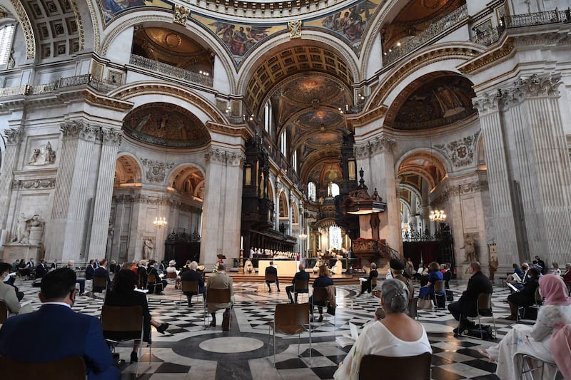 Guests sit on socially distanced seats as they attend a service at St Paul’s Cathedral in London.