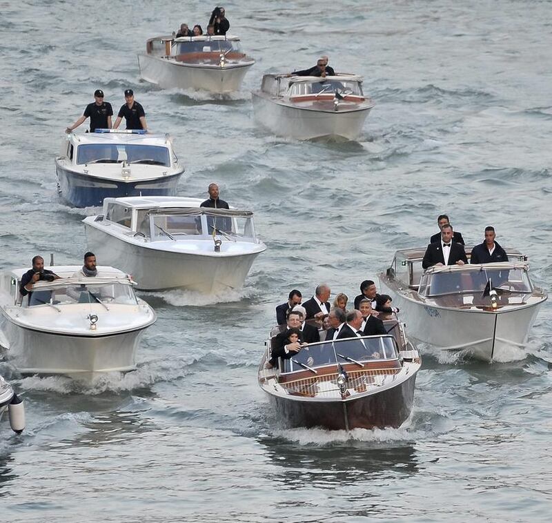George Clooney in a boat (centre) with family members and guests, cruises in the Grand Canal on their way to the Aman hotel ahead of his wedding. AP 