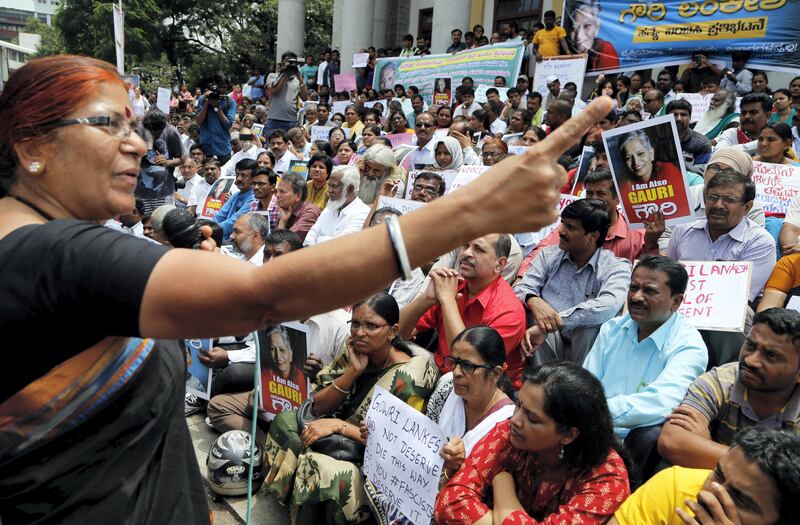A woman speaks at a protest demonstration against the killing of Indian journalist Gauri Lankesh in Bangalore, India, Wednesday, Sept. 6, 2017. The Indian journalist was gunned down outside her home the southern city of Bangalore ������� the latest in a string of deadly attacks targeting journalists or outspoken critics of religious superstition and extreme Hindu politics. (AP Photo/Aijaz Rahi)