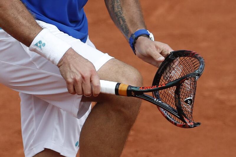 Switzerland’s Stan Wawrinka smashes his racquet in frustration. AP Photo