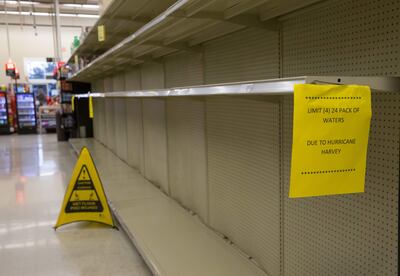 An Austin-Area grocer shelves are empty as they keep bottled water and other essential items stocked and sell limited quantities on August 27, 2017, during the aftermath of Hurricane Harvey which hit the Texas Golf coast.
Tropical Storm Harvey lashed central Texas with torrential rains on Sunday, unleashing "catastrophic" floods after the megastorm -- the most powerful to hit the United States since 2005 -- left a deadly trail of devastation along the Gulf Coast. / AFP PHOTO / SUZANNE CORDEIRO