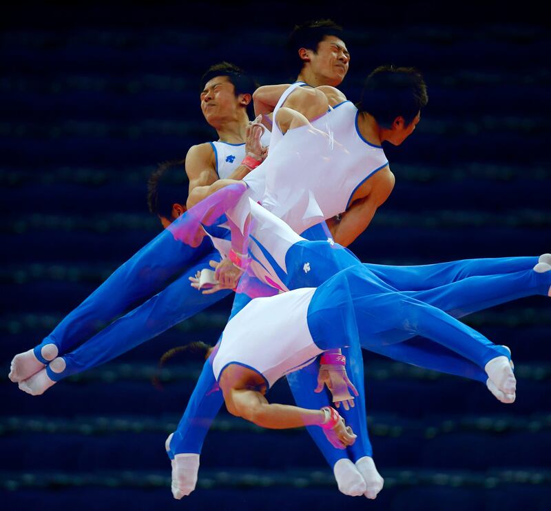 South Korea's Kim Soo-myun rotates above the horizontal bar during men's gymnastics podium training before the 2012 London Olympic Games in London July 25, 2012. Picture taken with multiple exposures.  REUTERS/Mike Blake  (BRITAIN - Tags: SPORT OLYMPICS GYMNASTICS)