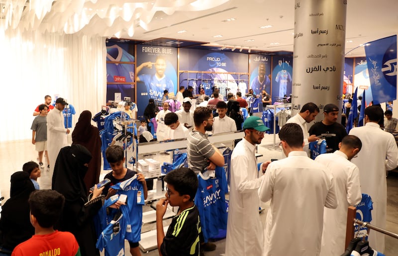 Fans buy Al Hilal jerseys of Neymar at the club shop. Reuters