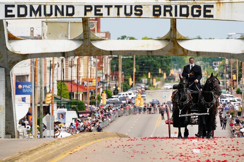 The late U.S. Congressman John Lewis, a key figure in the civil rights movement and long-time member of the U.S. House of Representatives, is carried via horse-drawn carriage across the Edmund Pettus Bridge in Selma, Alabama. Reuters