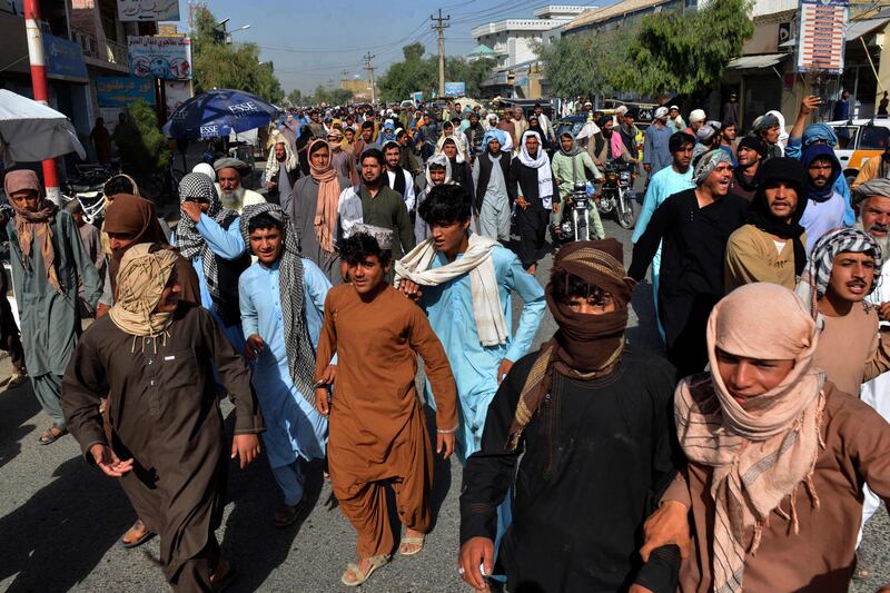 Local residents take part in a protest march against a reported announcement by the Taliban, asking them to evict their homes built on state-owned land in Kandahar. AFP