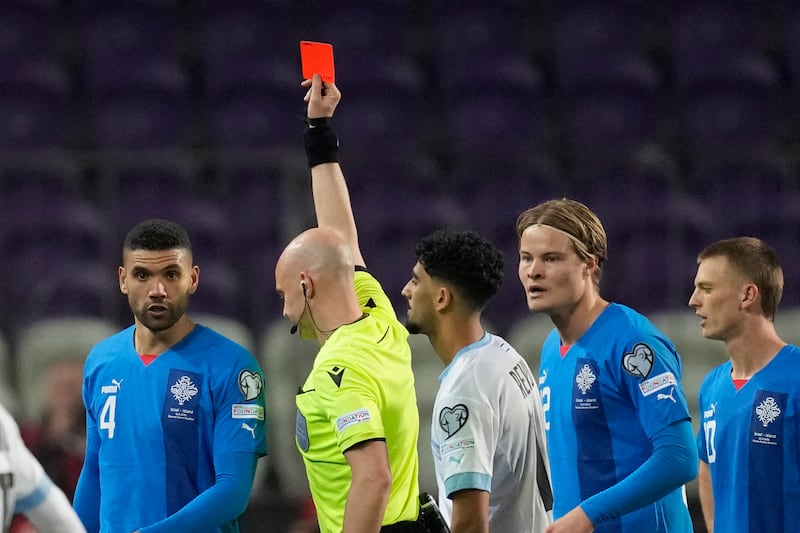 Israel's Roy Revivo receives a red card from referee Anthony Taylor. AP