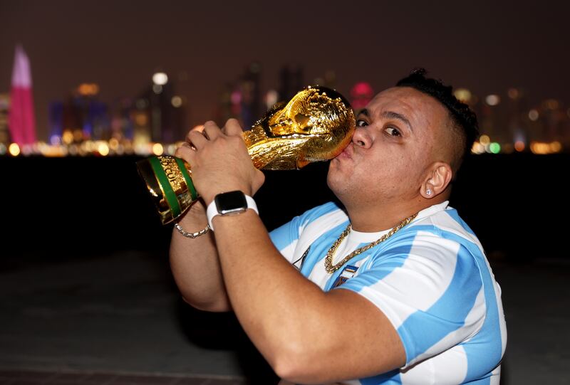 An Argentina fan in triumphant pose before the opening match between Qatar and Ecuador. Getty Images