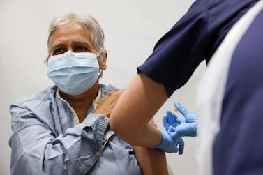 A person gets the coronavirus vaccine, at a vaccination centre in Westfield Stratford City shopping centre, in London, Britain. Reuters