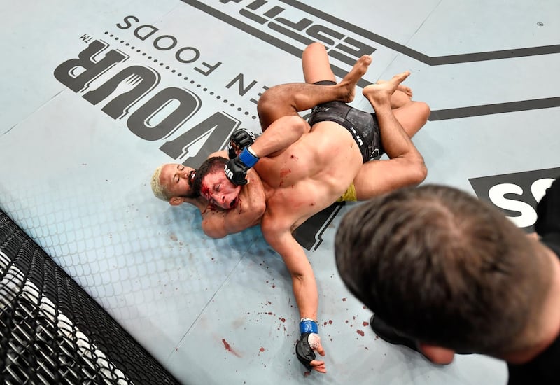 Deiveson Figueiredo, left, of Brazil secures a rear choke submission against Joseph Benavidez. Getty Images