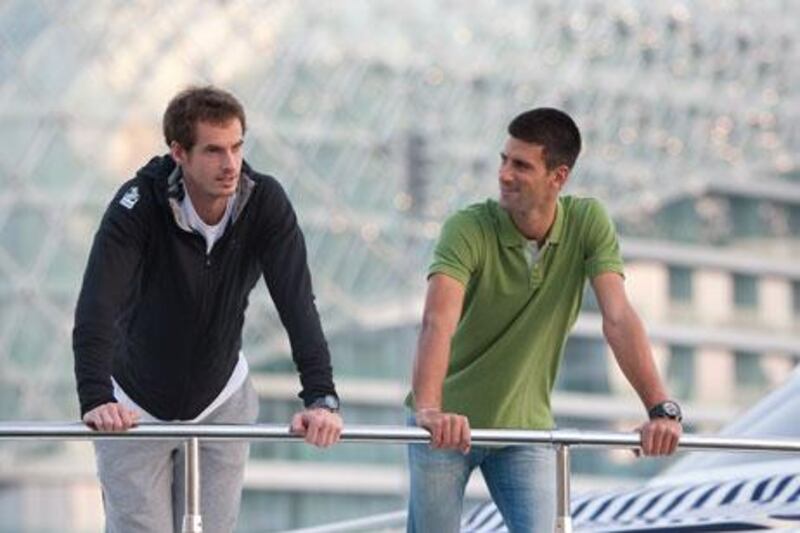 Andy Murray, left, the 2009 Mubadala World Tennis Championship winner, took some time from practice to chat with world No 1 Novak Djokovic, who won the previous Mubadala.