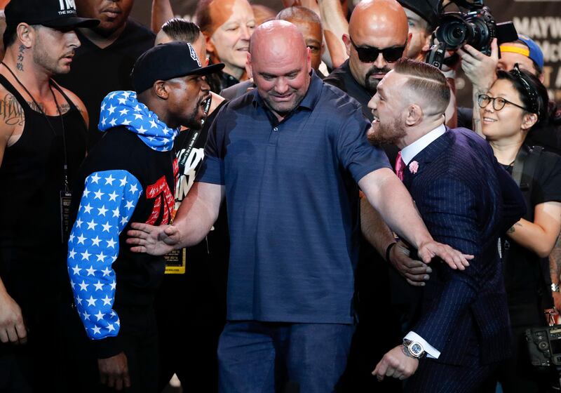 UFC president Dana White, centre, intervenes as boxer Floyd Mayweather Jr, left, and mixed martial arts fighter Conor McGregor exchange words during a news conference at Staples Center Tuesday, July 11, 2017, in Los Angeles.