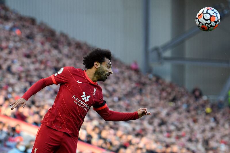 Liverpool's Egyptian midfielder Mohamed Salah heads the ball during the English Premier League football match between Liverpool and Manchester City at Anfield in Liverpool, northwest England, on October 3, 2021.  (Photo by Paul ELLIS / AFP) / RESTRICTED TO EDITORIAL USE.  No use with unauthorized audio, video, data, fixture lists, club/league logos or 'live' services.  Online in-match use limited to 120 images.  An additional 40 images may be used in extra time.  No video emulation.  Social media in-match use limited to 120 images.  An additional 40 images may be used in extra time.  No use in betting publications, games or single club/league/player publications.   /  