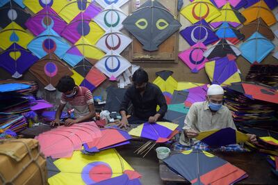 Kite makers prepare kites ahead of the Makar Sankranti at a workshop in Ahmedabad. AFP