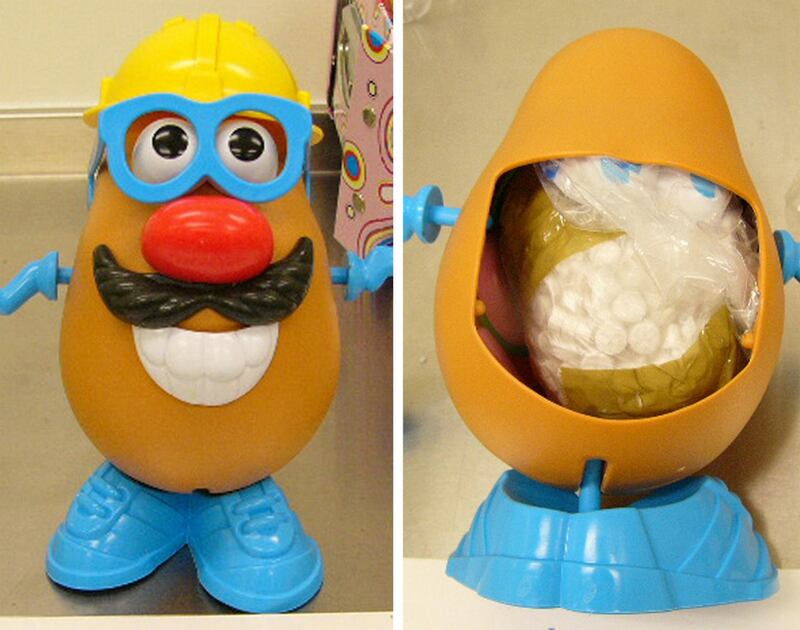 This combo of handouts made available by the Australian customs 04 October 2007, shows the popular children's toy Mr Potato Head, from the front (L), and a view from the rear in which ecstacy tablets were hidden, that was seized by Customs officers at the Sydney International Mail Centre. Customs officals said that they had discovered a large amount of ecstasy inside the Mr Potato Head mailed to Sydney from Ireland. When a panel from the toy's back was removed, a quantity of MDMA (ecstasy) tablets weighing an estimated 293 grams (10.3 ounces) was found in a small taped bag concealed in the cavity space.   AFP PHOTO / Australian Customs / HO (Photo by AFP / AUSTRALIAN CUSTOMS / AFP)