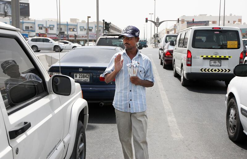 SHARJAH, UNITED ARAB EMIRATES Ð July 28: Sajaad Mohammed from Bangladesh selling peanuts at the traffic signal in Sharjah Industrial Area. He came to UAE 8 months back but lost his job and passport. Now he is selling these peanuts rolled in the paper for 1 dhs each. He earns around 25 to 30 dhs per day. (Pawan Singh / The National) For News. A Week In Feature