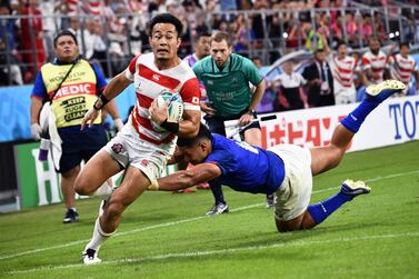 Japan winger Kenki Fukuoka evades a Samoan tackler to score a try at Toyota Stadium. AFP