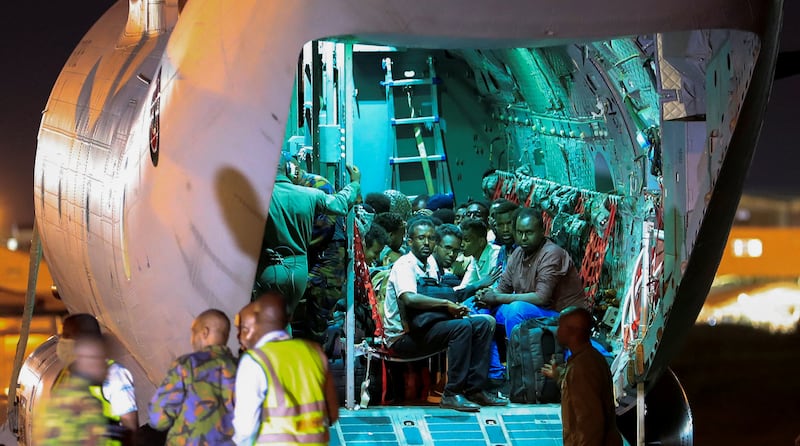 Evacuees from Sudan sit in a military plane as they wait to be processed by Kenyan troops in Nairobi on April 24. Reuters