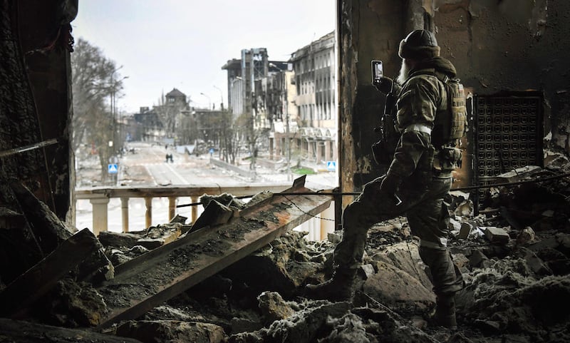 A Russian soldier patrols a bombed Mariupol theatre in April 2022, as Moscow intensified its campaign to take the strategic port city. AFP