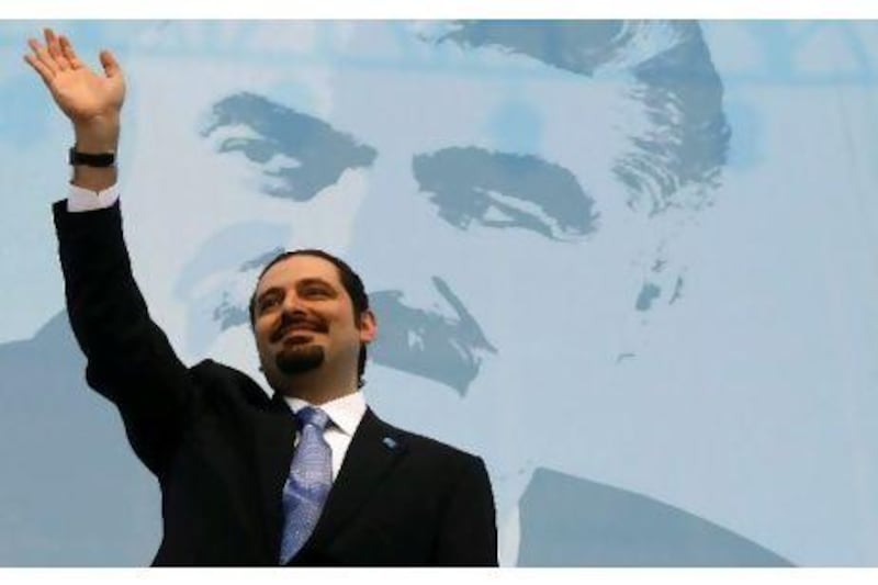 Lebanon's former prime minister Saad Hariri waving at his supporters in front of a portrait of his slain father and former premier Rafiq Hariri during a 2009 rally in Beirut.