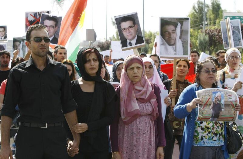 Faris (left), the son of the Syrian Kurdish opposition leader Meshaal Tamo, who was assassinated in Syria the previous day, gathers with supporters outside the Kurdistan parliament in the Iraqi Kurdish city of Arbil, as his father's funeral takes place in the northeastern Syrian city of Qamishli. Safin Hamed / AFP