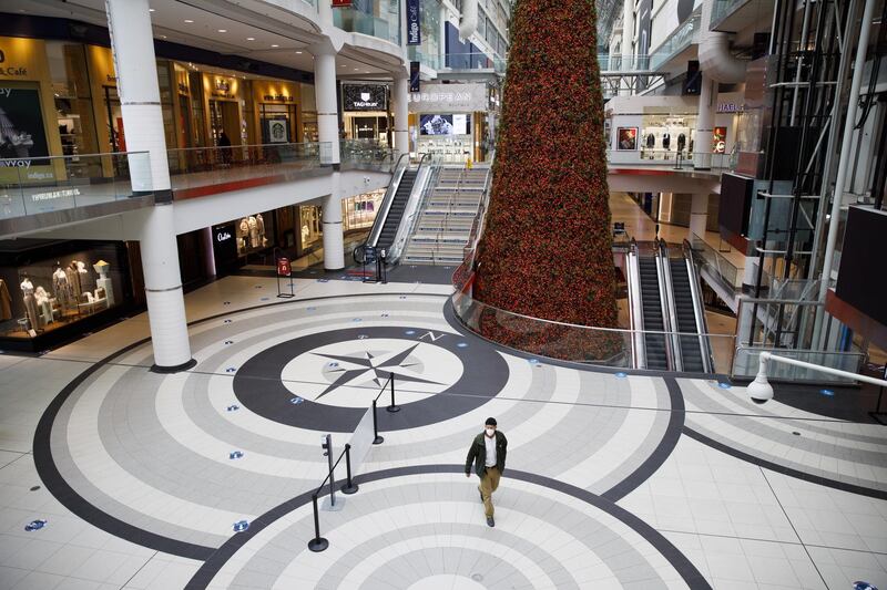 A shopper walks through a nearly empty Eaton Centre mall in Toronto, Ontario, Canada. Bloomberg