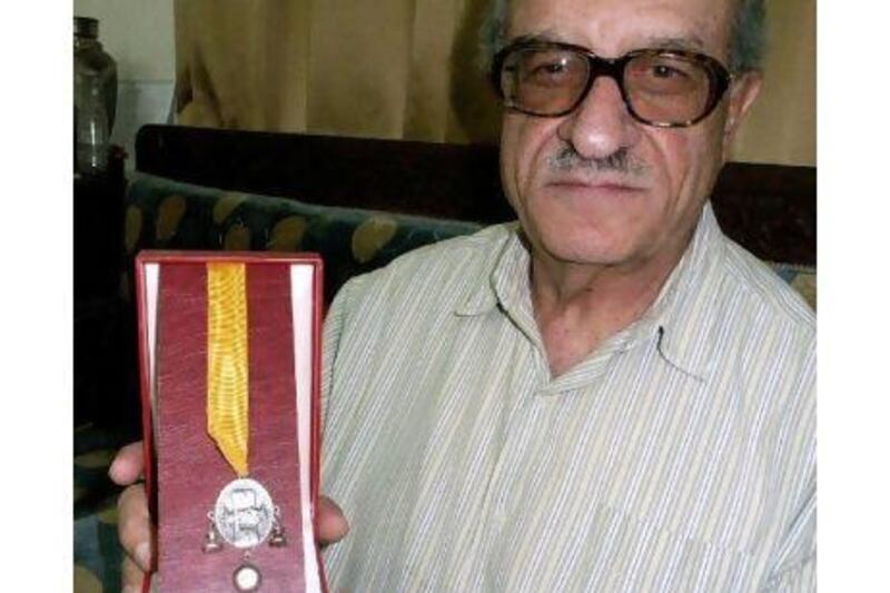 Haitham al Maleh, pictured in his Damascus office in 2006, holding a Dutch medal awarded for his human rights advocacy.