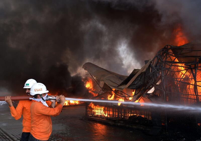 Pakistani firefighters try to put out a fire at a weekly market in Islamabad. All photos by Aamir Qureshi / AFP Photo