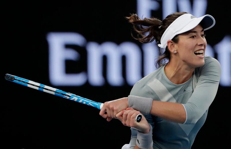 Spain's Garbine Muguruza follows through on a return shot to France's Jessika Ponchet during their first round match at the Australian Open tennis championships in Melbourne, Australia, Tuesday, Jan. 16, 2018. (AP Photo/Vincent Thian)