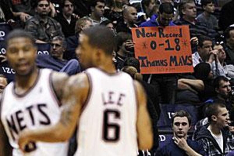 Fans hold up signs during the fourth quarter of the Nets' loss to the Dallas Mavericks.