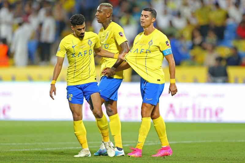 Al Nassr defender Ali Lajami with Cristiano Ronaldo. AFP
