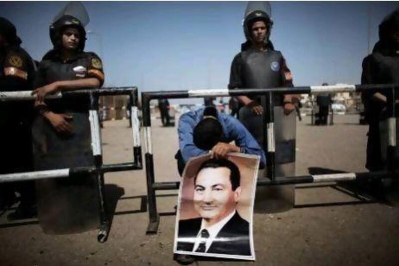 Supporters of Egypt's ousted president Hosni Mubarak react after hearing the verdict outside the heavily-guarded courthouse in Cairo. MARCO LONGARI / AFP PHOTO