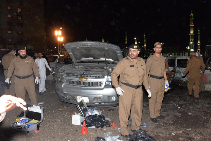 Saudi security personnel gather at the site of the suicide attack near the Prophet's Mosque in Medina on July 4, 2016. AFP