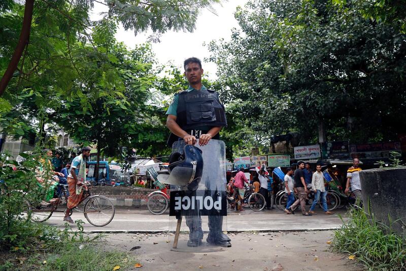 A Bangladeshi policeman on duty stand at a roadside in the Shahbag area of Dhaka, Bangladesh.  EPA / MONIRUL ALAM