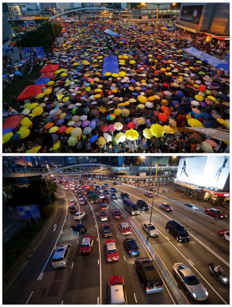 Top, protesters open their umbrellas, symbols of the pro-democracy movement, as they mark exactly one month since they took to the streets in Hong Kong's financial central district on October 28, 2014, and bottom, the same location on September 16, 2015. Reuters