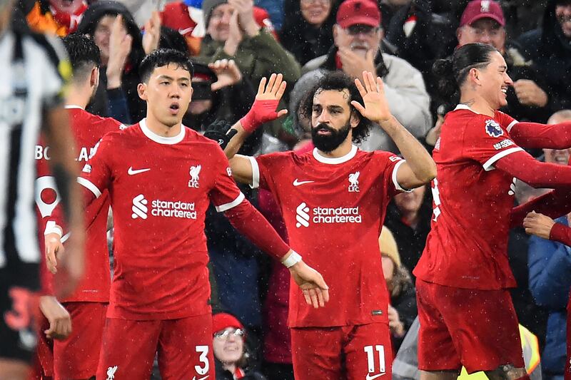Mohamed Salah celebrates with Liverpool teammates after scoring the opening goal. AFP