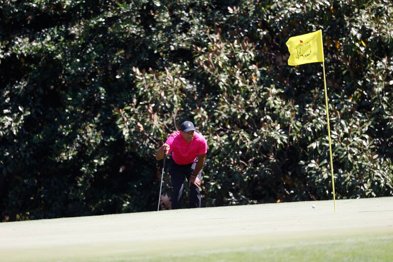 Tiger Woods  lines up his putt on the 11th hole. EPA