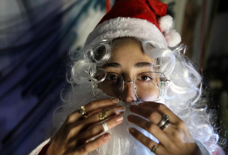 Melissa Freiha, 25, dressed as Santa Claus, adjusts her beard as she poses by her Christmas corner at her home in Mar Mikhael neighborhood of Beirut, Lebanon, December 10. Reuters