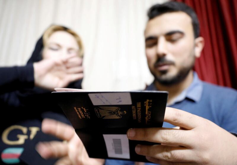 Amjad Yaghi shows his mother his Egyptian visa. Reuters